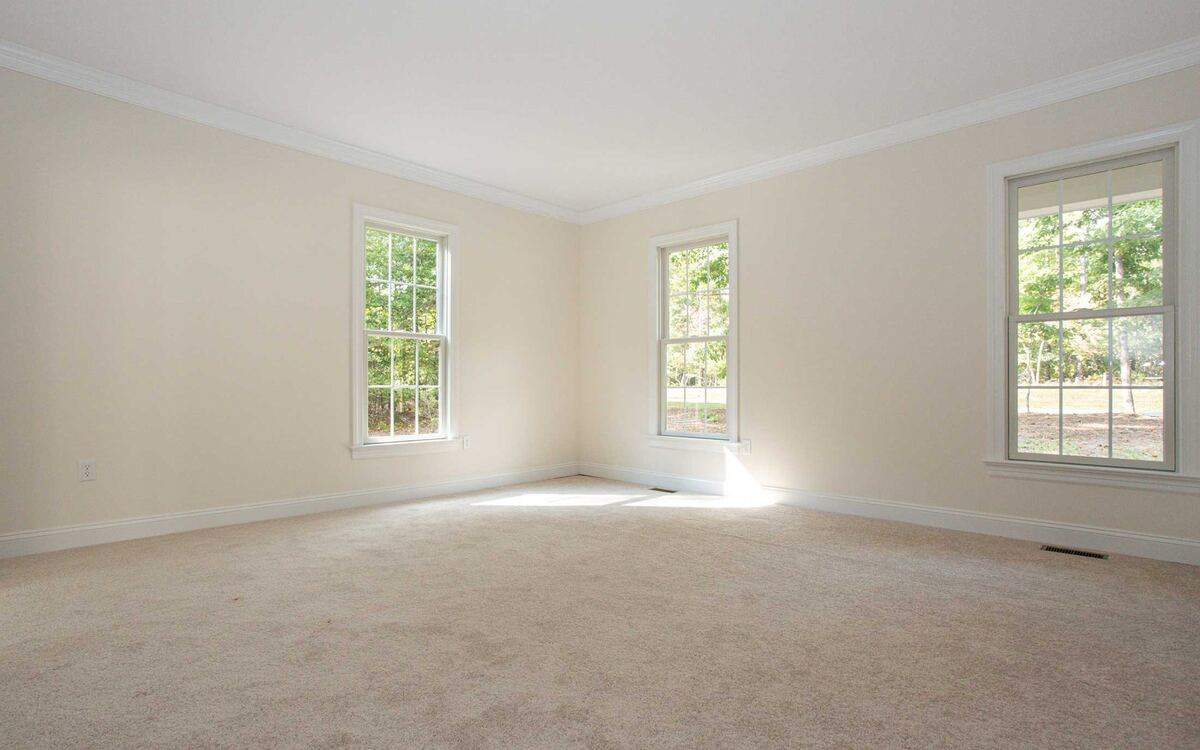Bright residential room with soft wall-to-wall carpet flooring
