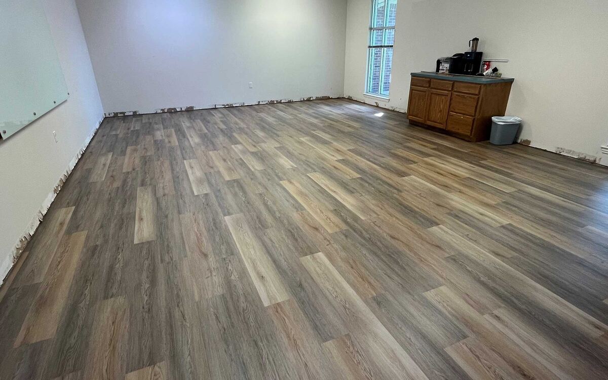 Office interior with installed glue-down LVP flooring